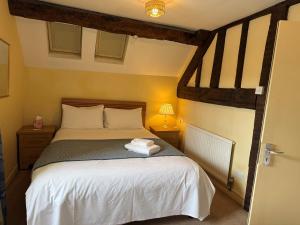 a bedroom with a bed with two towels on it at Yesterday's Guest House in Newtown