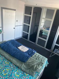 a bedroom with a bed and a large mirror at King size room in home for couple or females in Hornchurch