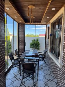 a screened porch with a table and chairs on it at My_willa_Buzovna in Zağulba Bağları