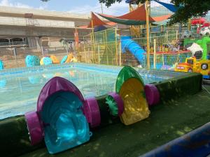 a water park with a large swimming pool at The Dunamis in Accra