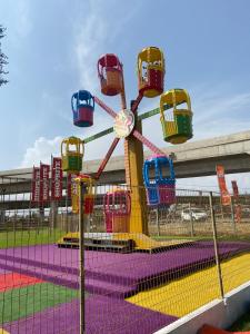 a colorful roller coaster ride on a playground at The Dunamis in Accra
