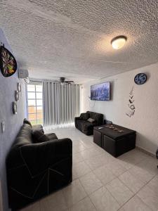 a living room with a couch and a table at Escape Acapulco in Acapulco