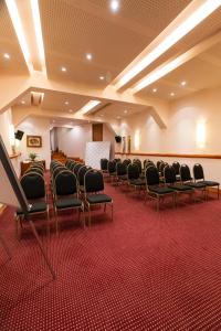 a room with a row of chairs and a stage at Sol Arrayan Hotel & Spa in Villa La Angostura +57 photos