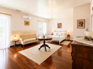 a living room with a table and a couch at Villa Golden Tiara Large Private Pool AC WiFi in Corfu