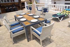 a wooden table and chairs on a patio at Zaks House Valle San Lorenzo in Arona
