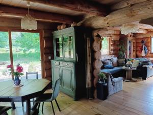 a living room with a green cabinet and a table at Lagarta La Fuste in Étival