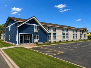 a large blue and white building with a parking lot at Days Inn by Wyndham Hinckley in Hinckley