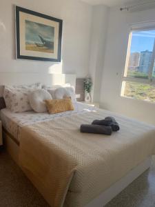a bed with two towels on it in a bedroom at Cabo Mar in El Campello +58 photos