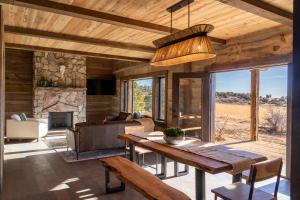 a living room with a table and a couch at Zion Mountain Ranch in Mount Carmel Junction