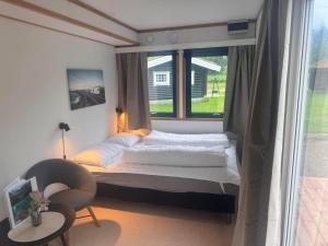 a bedroom with a bed and a window at Trollstigen Resort in Åndalsnes