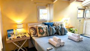 a bedroom with a bed with rolled towels on it at Maison La Torretta in Vico Equense