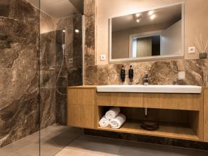 a bathroom with a sink and a mirror at Sleep & coffee by KAFEC in Komárov +8 photos