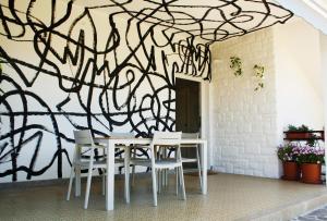 a dining room with a tree mural on the wall at Ema's double bedroom in Umag