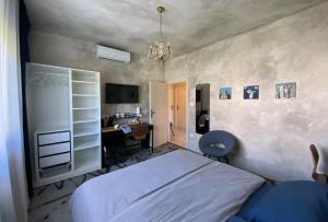a bedroom with a bed and a desk in it at Ema's double bedroom in Umag