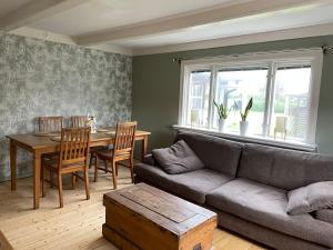 a living room with a couch and a table at Gästhus Vejbystrand in Vejbystrand