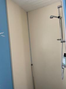 a shower in a room with a wall at Gästhus Vejbystrand in Vejbystrand +15 photos