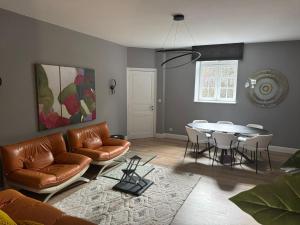 a living room with a couch and a table at Villa Damseaux in Spa