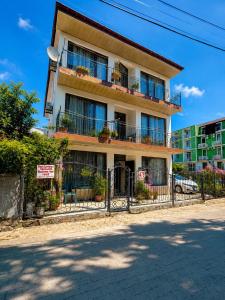 a building with a fence in front of it at APART HOTEL KOBULETi in Kobuleti