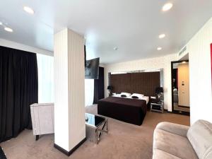 a hotel room with a bed and a couch at Apart Maristella sea view in Odesa