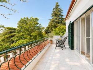 a balcony with a table and chairs on a house at Quinta do Carril in Reguengo