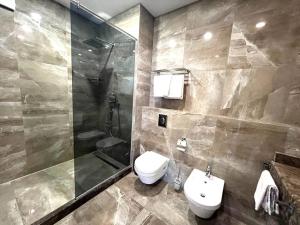 a bathroom with a toilet and a shower and a sink at Apart Maristella sea view in Odesa +22 photos