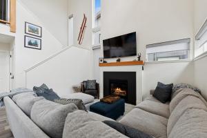 a living room with a couch and a fireplace at Quarry B8 in Whitefish