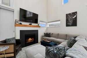 a living room with a couch and a fireplace at Quarry B8 in Whitefish