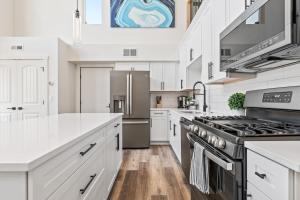 a kitchen with white cabinets and a stove at Quarry B8 in Whitefish