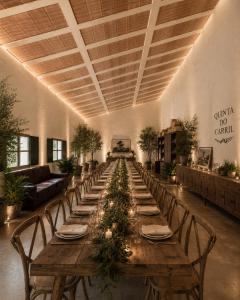 a long table with chairs and a long table with trees on it at Quinta do Carril in Reguengo
