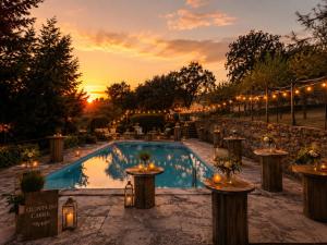 a pool with lights and a sunset in the background at Quinta do Carril in Reguengo