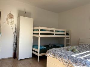 a bedroom with a bunk bed and a bunk bed at Apartma Laganini in Bosiljevo