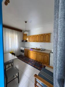 a kitchen with wooden cabinets and a table in it at AGAPI'S HOUSE in Sidirokastro