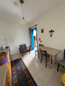 a kitchen and living room with a table and chairs at AGAPI'S HOUSE in Sidirokastro +11 photos