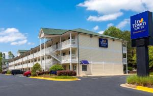 a hotel with a sign in front of a parking lot at InTown Suites Extended Stay Atlanta GA - Suwanee in Suwanee