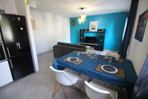 a blue table and chairs in a living room at T2 moderne, Parking, Proche Valence & Autoroute in Bourg-lès-Valence