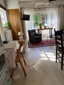 a living room with a table and a chair at For a wonderful outdoor feeling! in Zelhem