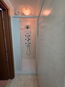 a walk in shower in a bathroom with a light at La casa di Claudia Torre Suda in Torre Suda +22 photos