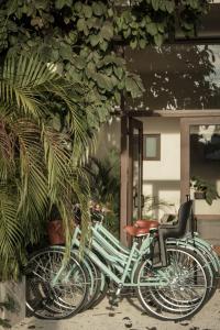 two bikes parked in front of a building at Hotel Lydna Ki'n in Bacalar