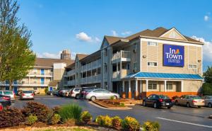 a hotel with cars parked in a parking lot at InTown Suites Extended Stay Atlanta GA - West Midtown in Atlanta