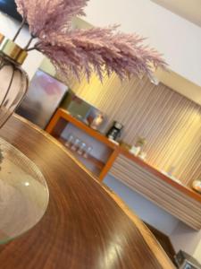 a wooden table with a vase on top of it at Hotel Tlayolan in Ciudad Guzmán