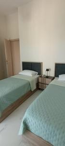 two beds sitting next to each other in a bedroom at Twins house pool 1 in Nikiti +71 photos