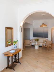 a living room with a table and a couch at Galini Rooms in Naousa