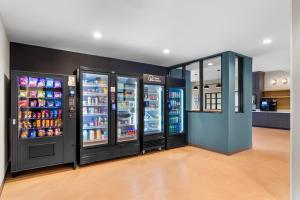 a store with three refrigerators in a room at StudioRes by Marriott Memphis Cordova in Cordova