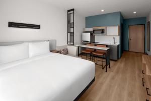 a hotel room with a bed and a kitchen at StudioRes by Marriott Memphis Cordova in Cordova