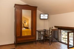 a room with a mirror and a table and a bed at Il Castello di San Sergio in Centola