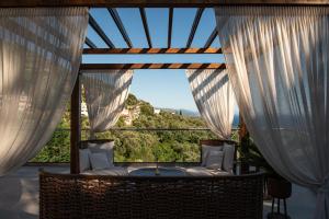 a room with a large window with white curtains at Suite Home in Anthoúsa