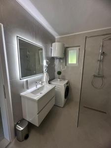 a white bathroom with a sink and a shower at Villa Ramea in Kovačevo Polje +28 photos
