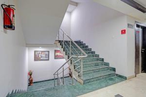 a staircase in a building with green tiles at Collection O Dhanbad Railway Station Formerly Hotel VIP Residency in Dhanbād