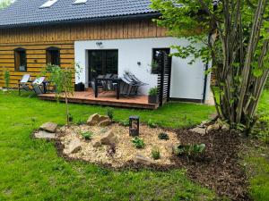 a backyard with a wooden deck and a house at Chalupa na Kopci in Liberec