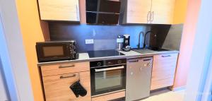 a small kitchen with a sink and a stove at LE BARCARES Logement "Marenda" climatisé avec terrasse, plage à pied, place de parking - 4 personnes in Le Barcarès